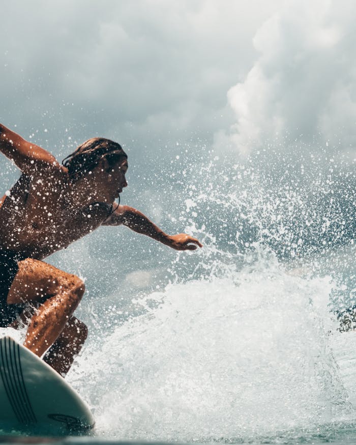 services-02 Energetic surfer rides ocean waves in tropical Indonesia, capturing the thrill of water sports.